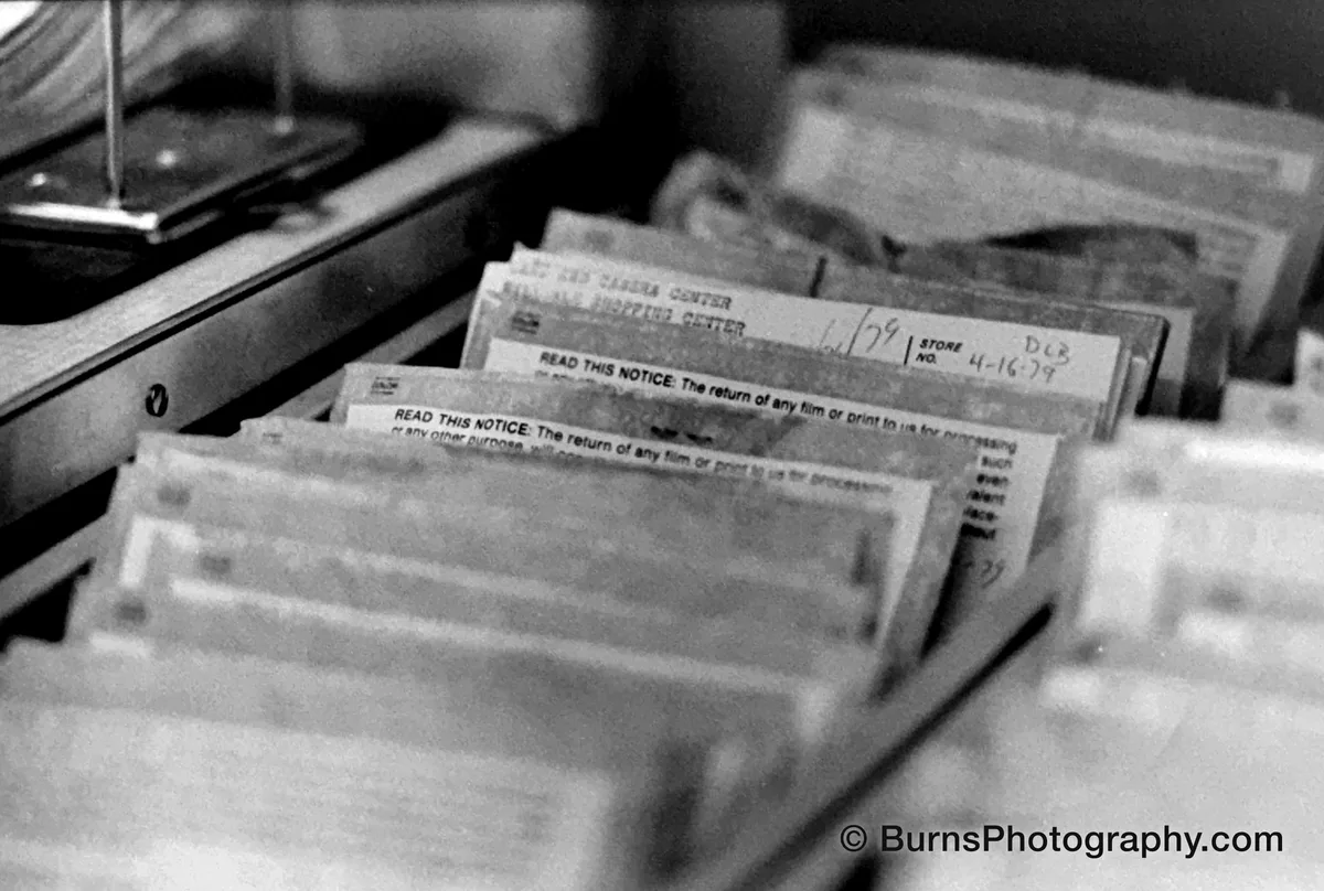 Close-up of film processing envelopes in a drawer, one hand-dated 4-16-79