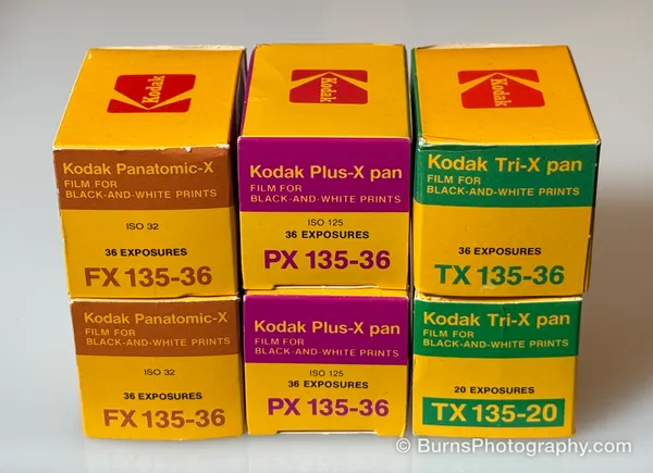 Six yellow Kodak 35mm film boxes: Panatomic-X, Plus-X pan, and Tri-X pan.